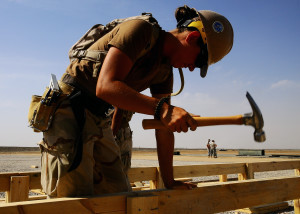 090430-N-0981M-041 KANDAHAR, Afghanistan (April 30, 2009) Builder 3rd Class Amy Higgins, a crewmember from Naval Mobile Construction Battalion (NMCB) 11 Air Detachment Afghanistan , pounding a nail into the floor beam of a Southwest Asia (SWA) Hut at Kandahar Air fField, Afghanistan. NMCB 11 is deployed with the amphibious transport dock ship USS Nashville (LPD 13) supporting Africa Partnership Station, a multinational initiative developed by Commander, U.S. Naval Forces Europe and Commander, U.S. Naval Forces Africa to work with U.S. and international partners to enhance maritime safety and security in West and Central Africa. (U.S. Navy photo by Mass Communication Specialist 3rd Class Jeffrey R. Militzer/Released)